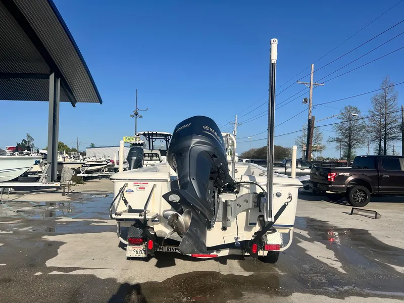 Slide: The Image of 2013 Sea Hunt BX 22 Pro boat with outboard motor on trailer in marina. - 3