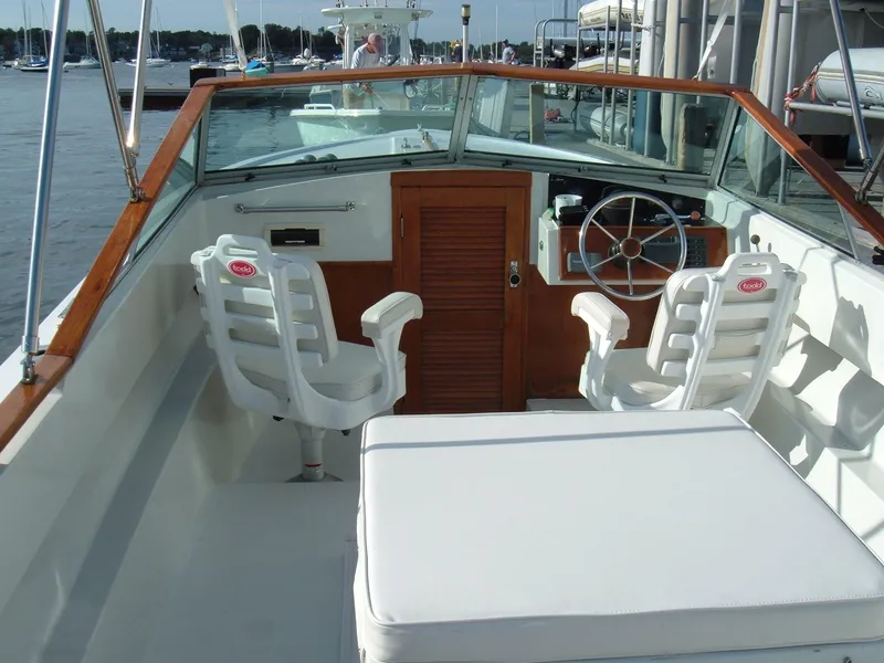 Slide: The Image of 1978 Lyman 24 Sportsman boat interior with white seating and wooden accents. - 10