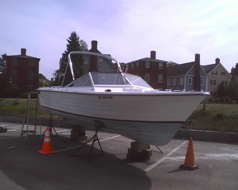 Slide: The Image of 1978 Lyman 24 Sportsman boat on stands, with traffic cones, in a residential area. - 14