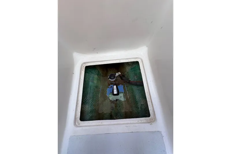 Slide: The Image of Bilge compartment of a 1978 Lyman 24 Sportsman boat, showing pump and wiring. - 15