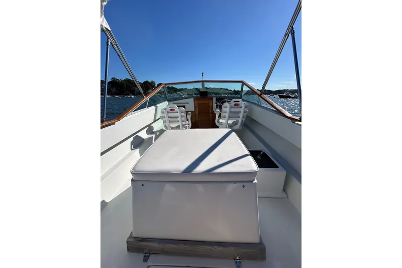 Slide: The Image of 1978 Lyman 24 Sportsman boat interior with seating, on a sunny day at sea. - 17