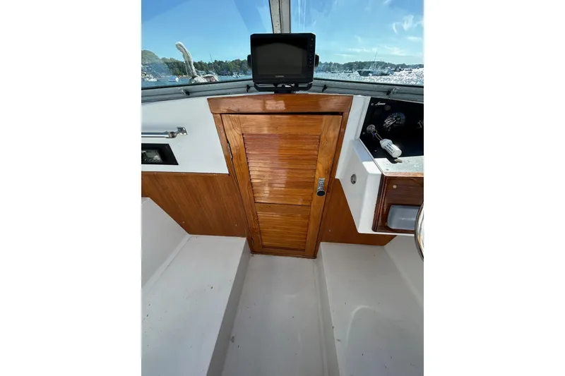 Slide: The Image of 1978 Lyman 24 Sportsman boat interior with wooden door and control panel. - 22