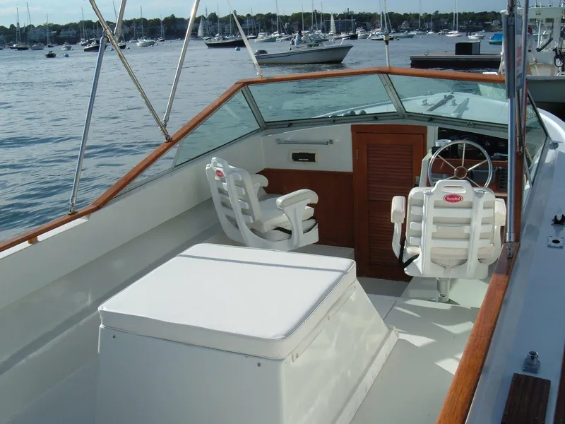 Slide: The Image of 1978 Lyman 24 Sportsman boat interior with white seating and wooden accents. - 4