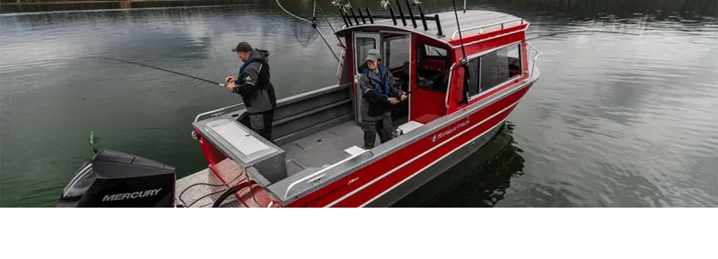 Slide: The Image of 2024 Spartan 240 Maximus Pro boat on trailer, red exterior, parked in snowy lot. - 1