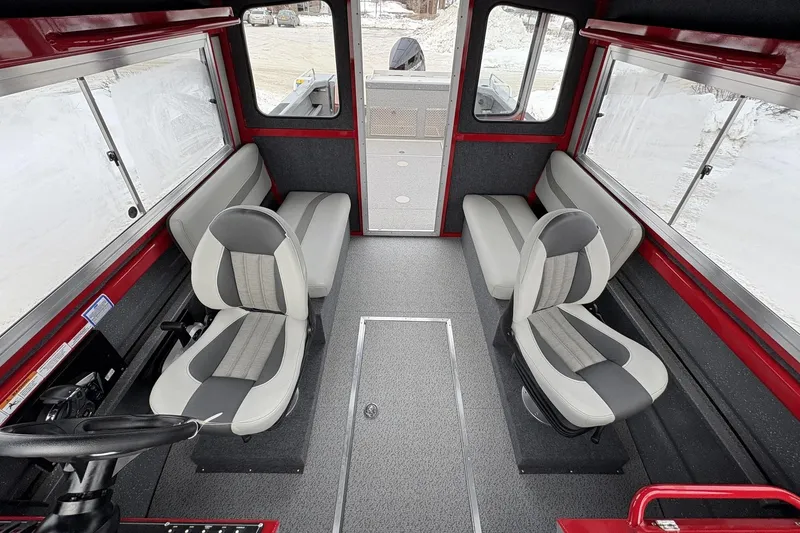 Slide: The Image of 2024 Spartan 240 Maximus Pro interior with gray seating and red accents. - 10