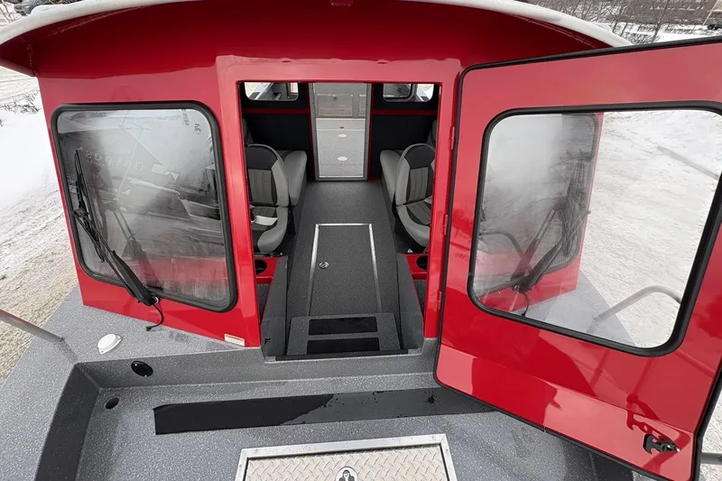 Slide: The Image of Red 2024 Spartan 240 Maximus Pro boat interior with open doors and seating. - 13