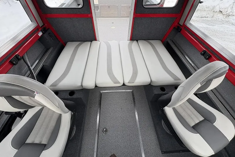 Slide: The Image of 2024 Spartan 240 Maximus Pro interior with gray and white seating, red accents, and modern design. - 14