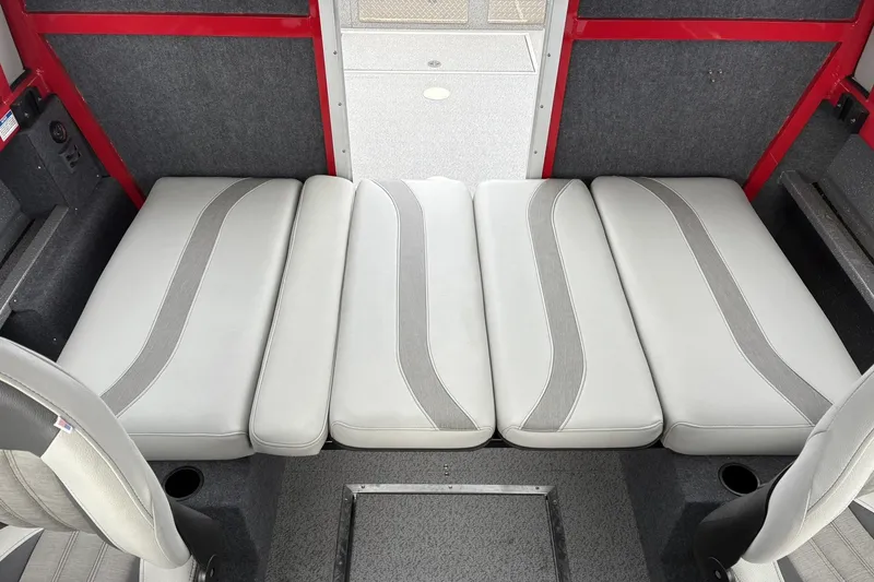 Slide: The Image of 2024 Spartan 240 Maximus Pro interior with gray cushioned seating and red accents. - 15
