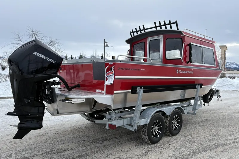 Slide: The Image of 2024 Spartan 240 Maximus Pro boat on trailer, red exterior, Mercury engine, snowy background. - 3