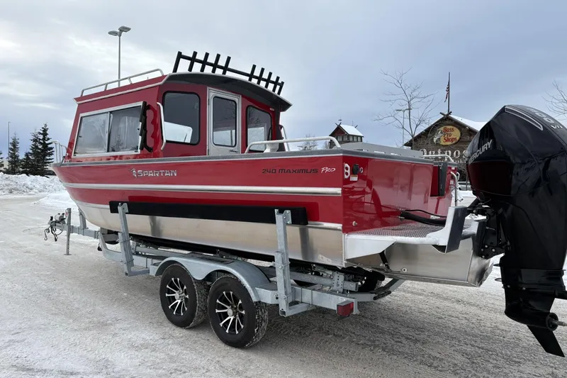 Slide: The Image of 2024 Spartan 240 Maximus Pro boat on trailer in snowy setting. - 4