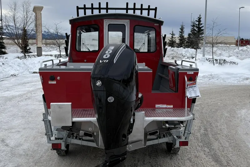 Slide: The Image of 2024 Spartan 240 Maximus Pro boat with powerful outboard motor in snowy setting. - 5