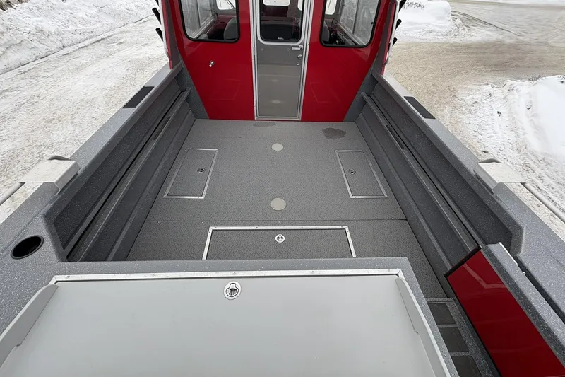 Slide: The Image of 2024 Spartan 240 Maximus Pro boat interior with spacious deck and red cabin. - 6