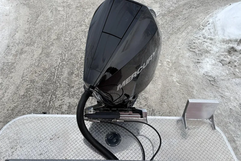 Slide: The Image of 2024 Spartan 240 Maximus Pro with Mercury outboard motor on snowy ground. - 8