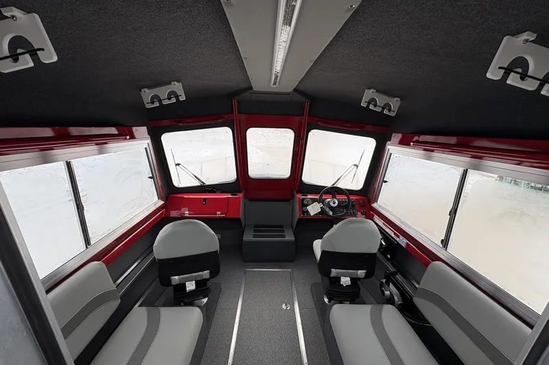 Slide: The Image of Interior of 2024 Spartan 240 Maximus Pro boat, featuring modern seating and dashboard. - 9