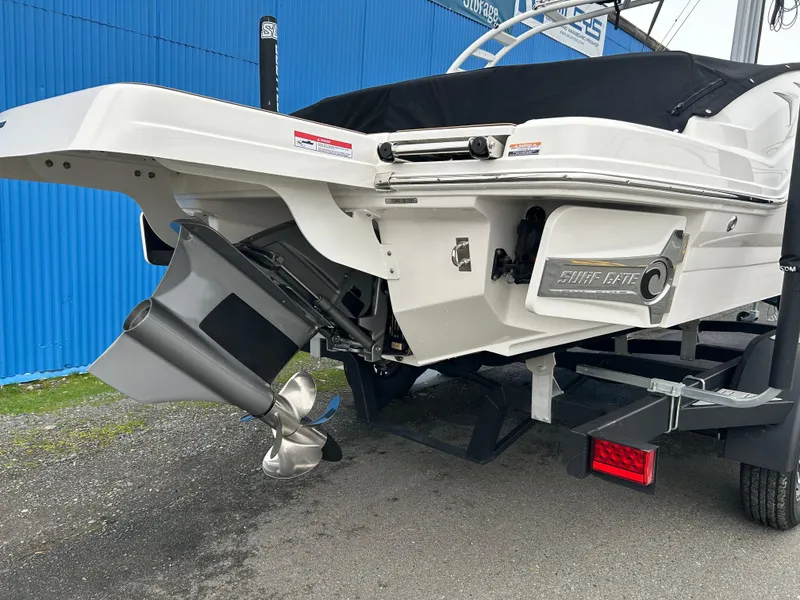 Slide: The Image of 2024 Chaparral 23 Surf boat rear view with propeller and sleek design. - 7