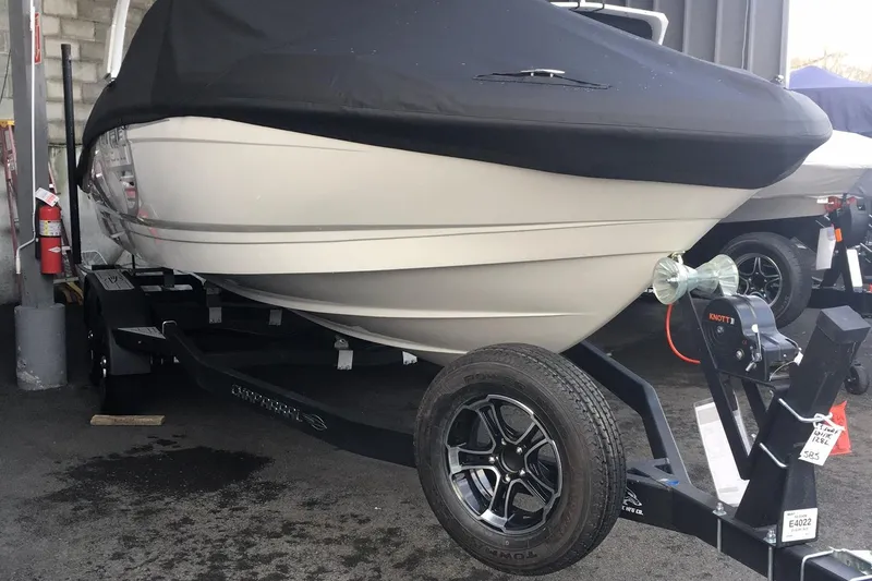 Slide: The Image of 2024 Chaparral 23 Surf boat on trailer, covered, parked indoors. - 9