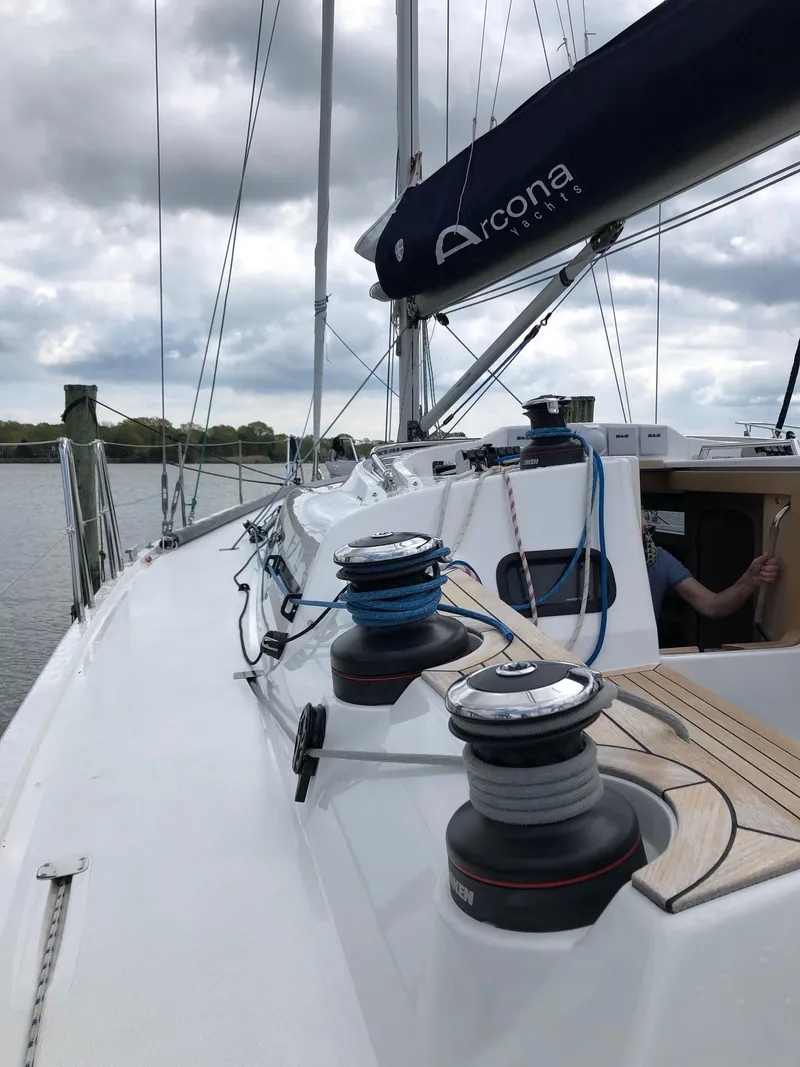 Slide: The Image of 2020 Arcona 435 sailboat deck with winches and rigging, under cloudy skies. - 25