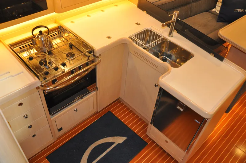Slide: The Image of Modern kitchen in 2020 Arcona 435 yacht with stove, sink, and wooden flooring. - 28