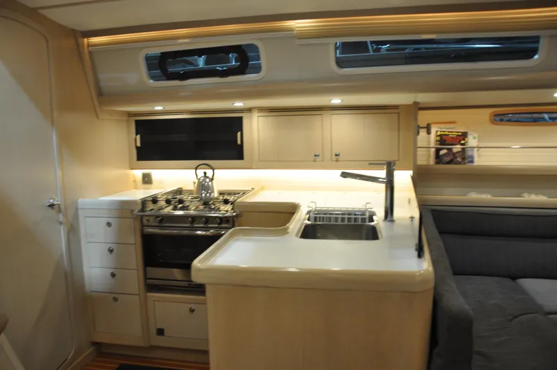 Slide: The Image of 2020 Arcona 435 yacht interior with modern kitchen and seating area. - 35
