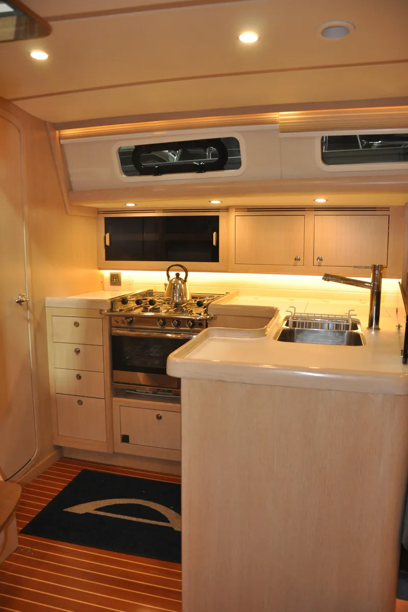 Slide: The Image of 2020 Arcona 435 yacht interior kitchen with modern appliances and wooden cabinetry. - 36