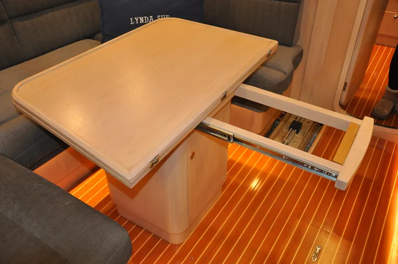 Slide: The Image of Interior of 2020 Arcona 435 yacht with extendable wooden table and cushioned seating. - 42