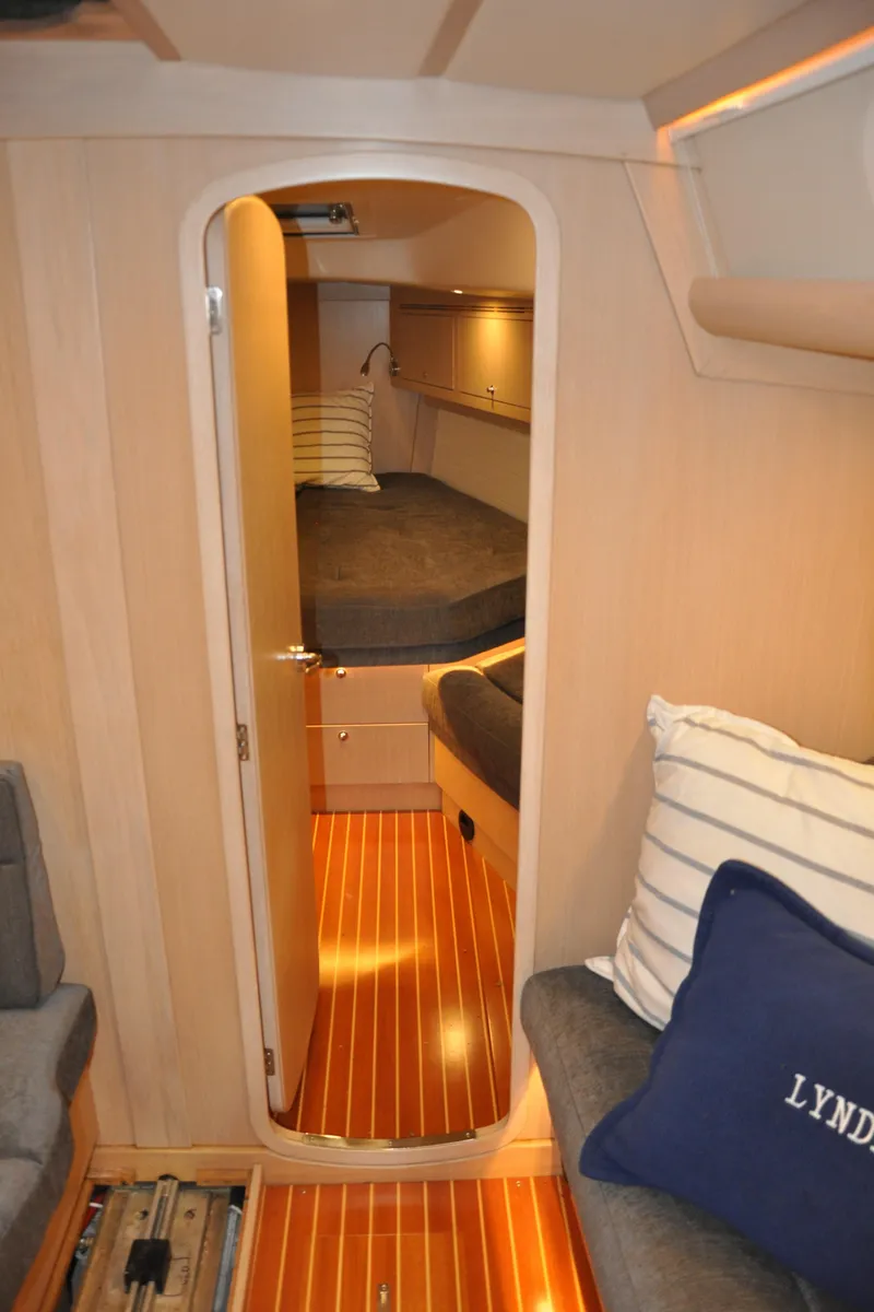 Slide: The Image of 2020 Arcona 435 yacht interior with cozy cabin, wooden flooring, and modern furnishings. - 43