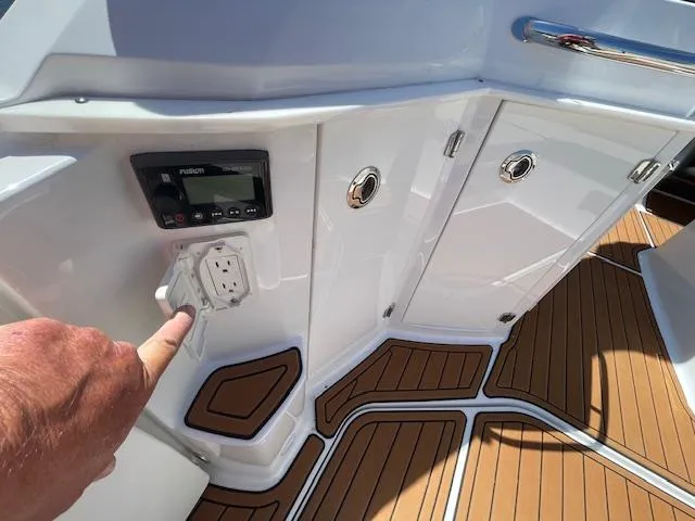 Slide: The Image of 2019 Monterey 295 boat interior with control panel and wooden flooring. - 15