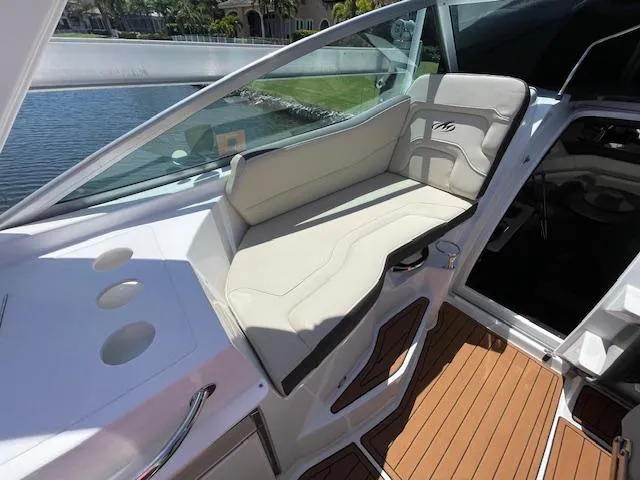 Slide: The Image of 2019 Monterey 295 boat interior with beige seating and wooden flooring. - 18