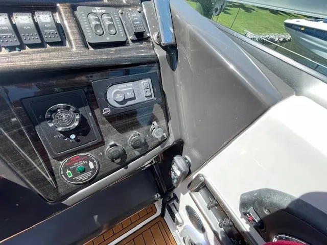 Slide: The Image of Control panel of a 2019 Monterey 295 boat with various switches and dials. - 23