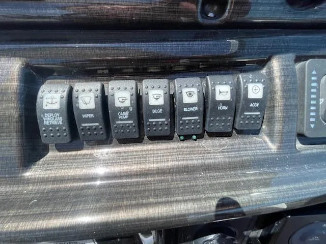 Slide: The Image of Control panel of a 2019 Monterey 295 boat with labeled switches. - 25