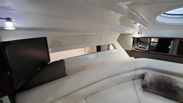 Slide: The Image of Luxurious interior of a 2019 Monterey 295 boat with plush seating and a mounted TV. - 31