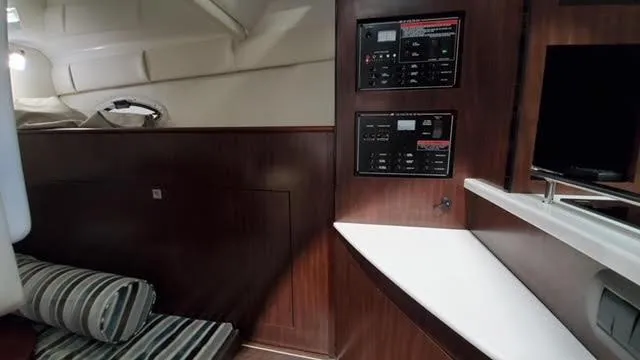 Slide: The Image of 2019 Monterey 295 cabin interior with control panels and striped seating. - 39
