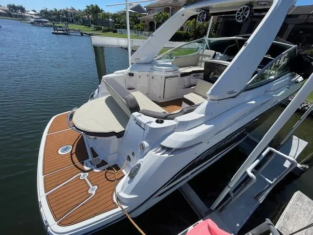 Slide: The Image of 2019 Monterey 295 boat docked, featuring spacious deck and luxurious seating. - 4