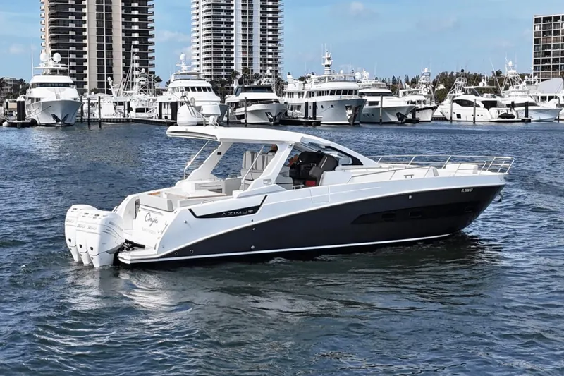 Slide: The Image of Azimut 40 Verve 2020 yacht cruising in a marina with skyscrapers in the background. - 1