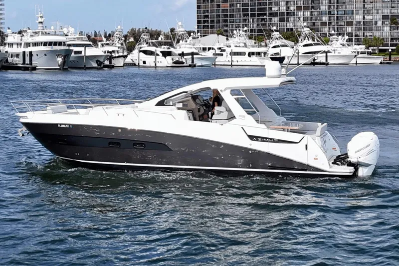 Slide: The Image of 2020 Azimut 40 Verve yacht cruising in a marina with other boats in the background. - 10