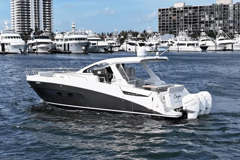 Slide: The Image of Azimut 40 Verve 2020 yacht cruising in a marina with luxury boats in the background. - 11