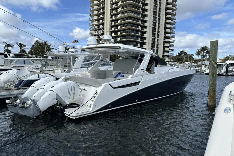 Slide: The Image of 2020 Azimut 40 Verve yacht docked at marina with modern high-rise in background. - 12