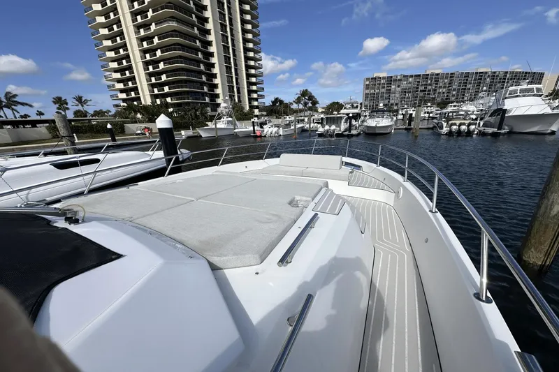 Slide: The Image of 2020 Azimut 40 Verve yacht docked in a marina with modern buildings nearby. - 15