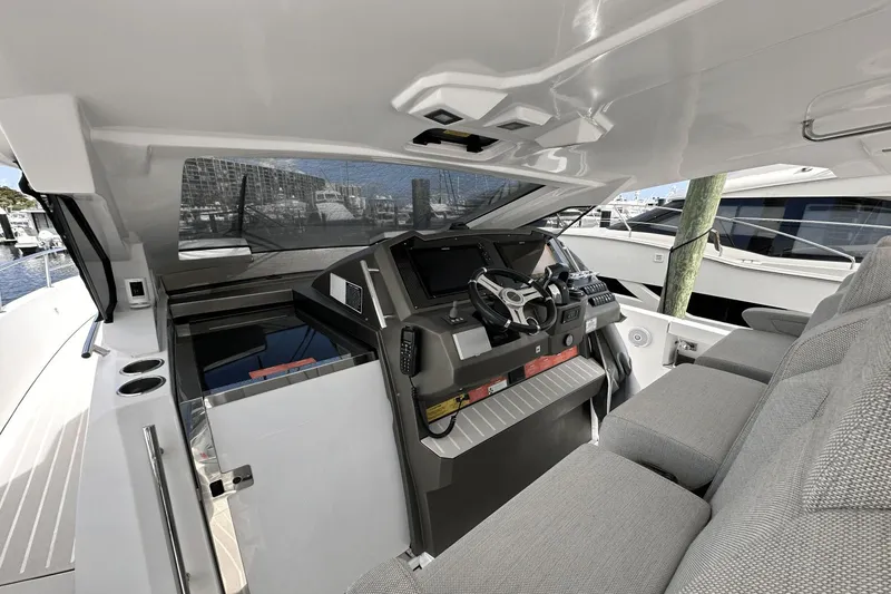 Slide: The Image of Helm of 2020 Azimut 40 Verve yacht with modern controls and seating. - 17
