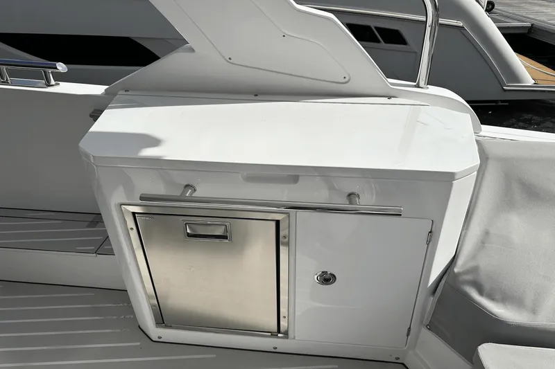 Slide: The Image of 2020 Azimut 40 Verve yacht interior with sleek white cabinetry and stainless steel accents. - 20