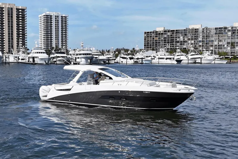 Slide: The Image of 2020 Azimut 40 Verve yacht cruising in a marina with high-rise buildings in the background. - 3