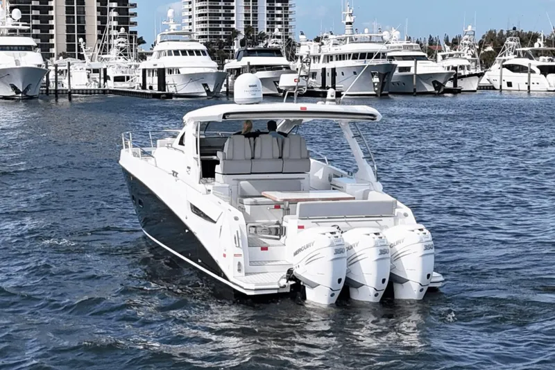 Slide: The Image of Azimut 40 Verve 2020 yacht cruising in a marina with multiple boats docked. - 5