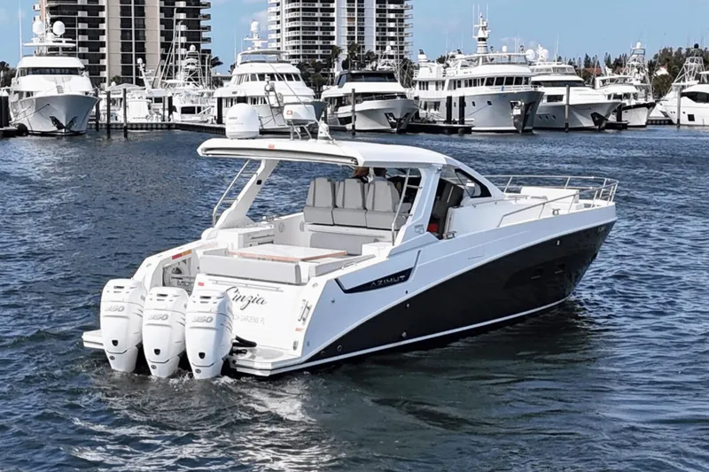 Slide: The Image of Azimut 40 Verve 2020 yacht cruising in a marina with luxury boats in the background. - 6