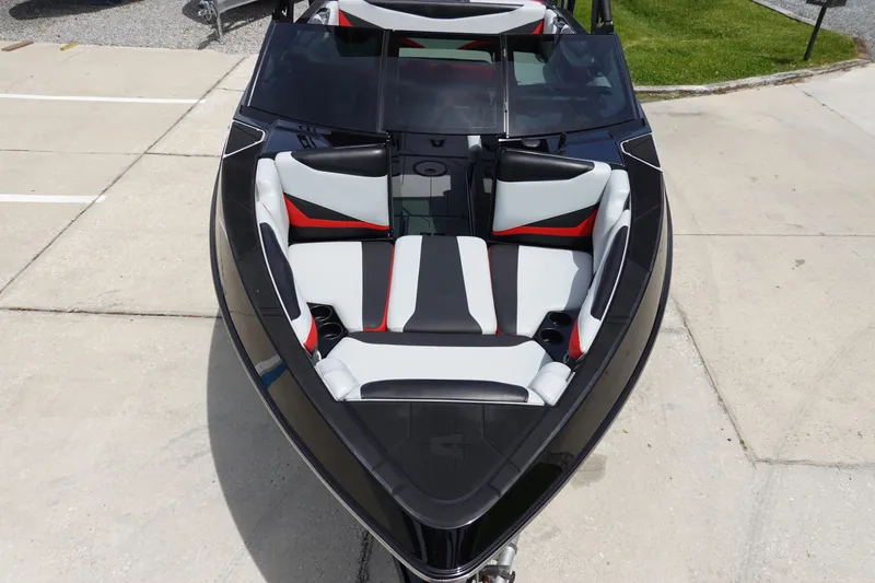 Slide: The Image of 2019 Axis T22 boat with black and white interior, docked on concrete. - 10