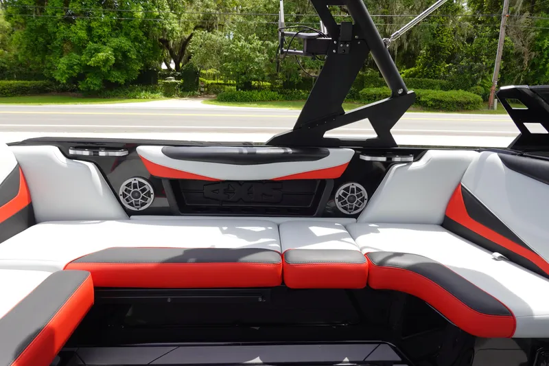 Slide: The Image of 2019 Axis T22 boat interior with red and white seating, speakers, and wakeboard tower. - 17