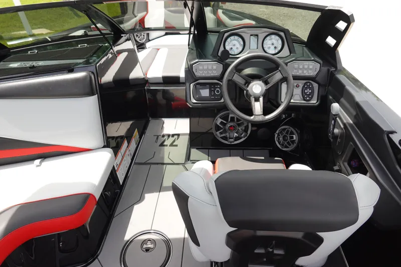 Slide: The Image of 2019 Axis T22 boat interior with steering wheel, dashboard, and seating. - 22