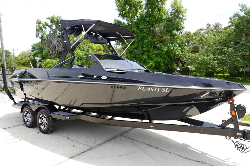 Slide: The Image of 2019 Axis T22 boat on trailer, black exterior, parked outdoors. - 3