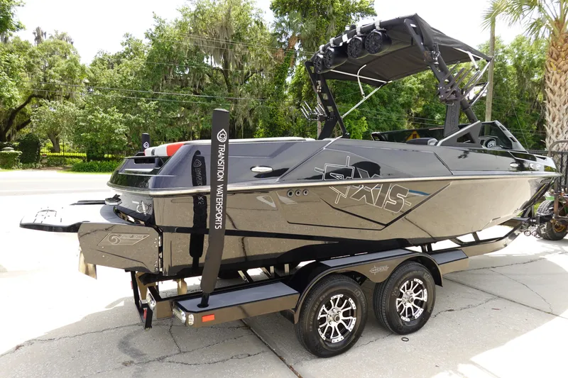 Slide: The Image of 2019 Axis T22 boat on a trailer, black exterior, parked outdoors. - 5