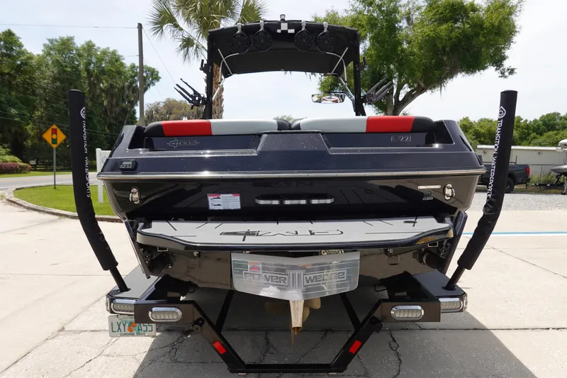 Slide: The Image of 2019 Axis T22 boat rear view on trailer, parked outdoors. - 7
