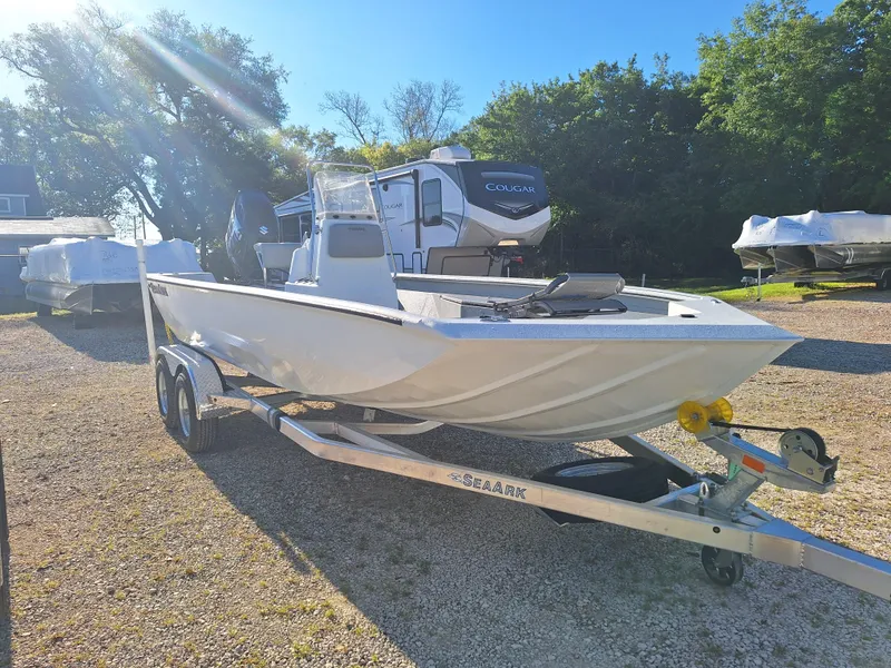 The Image of 2024 SeaArk 210 Bayrunner boat on a trailer in a sunny outdoor setting. - 1